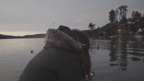 mujer sentada junto al lago