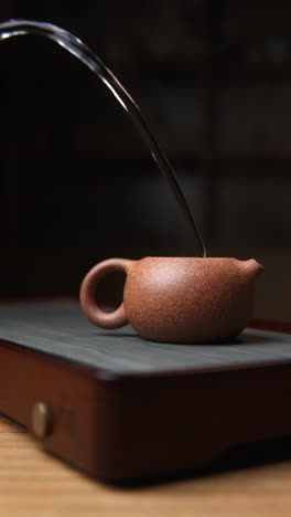 pouring tea into yixing teapot