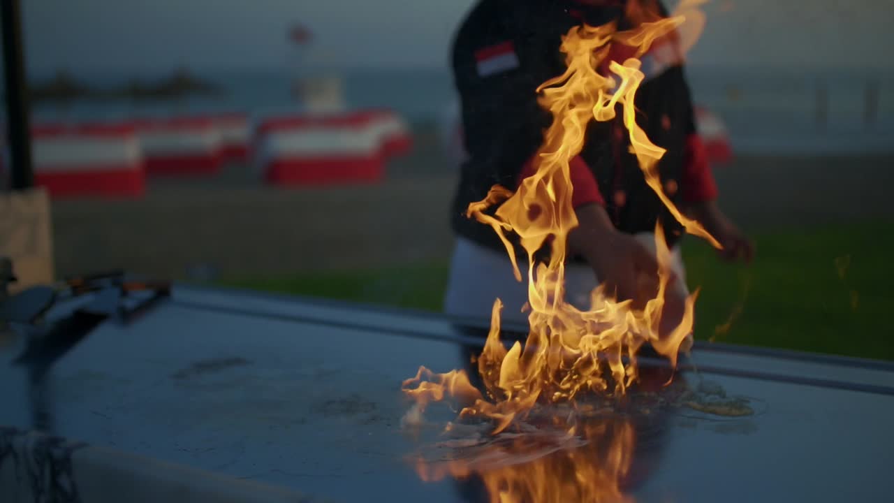 Chef Cooking Delicious Food on a Teppanyaki Grill by the Sea