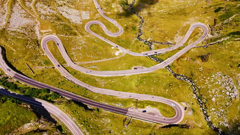 stunning wavy highway on the mountain slopes. sunny scenery of transfagarash highway in romania. aerial view