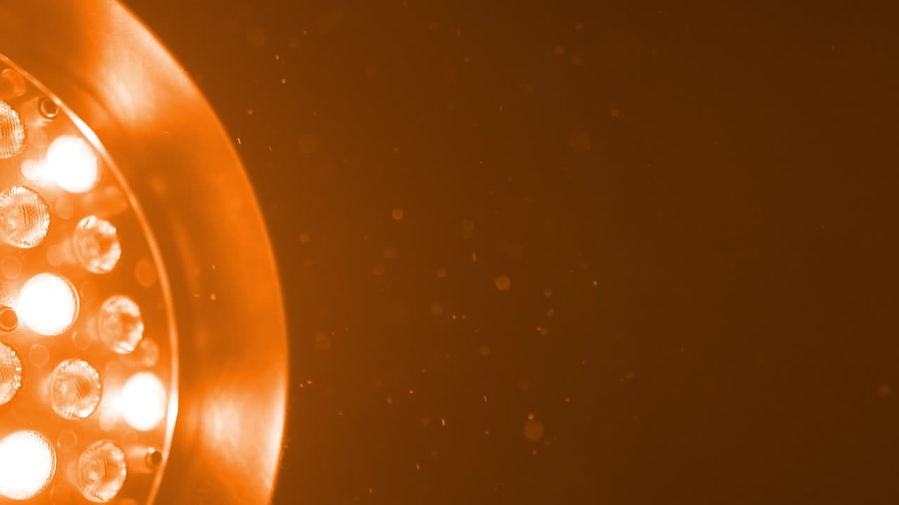 Oranges light revealing small dust particles, slow motion.