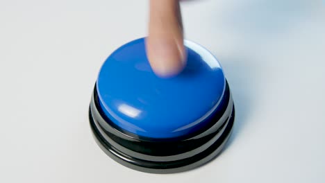 young woman pushing blue button with a finger and palm of her hand. press a round glossy button, top view. activation, launching something. turn on and off.