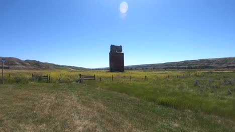 old wooden grain tower in the country near alberta canada during the summer
