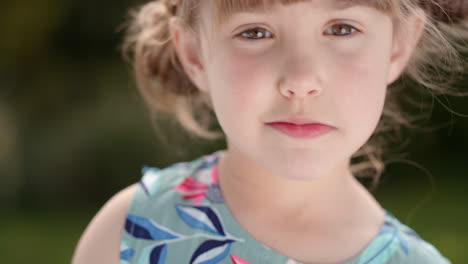 portrait happy little girl smiling with playful excitement looking at camera enjoying childhood fun in sunny park 4k footage