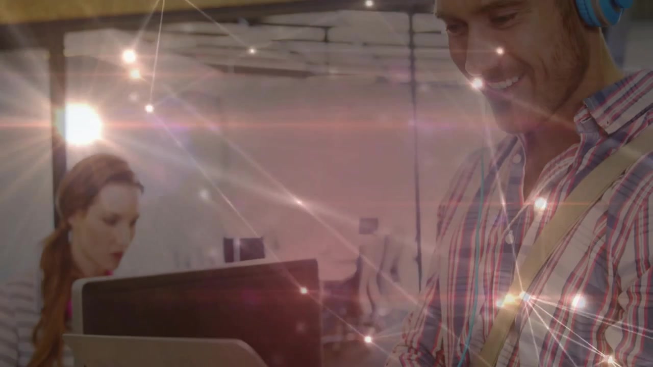 Man Using Laptop with Digital Network Overlay in Modern Office