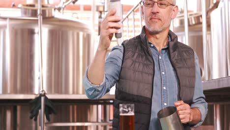 brewery worker checking the product