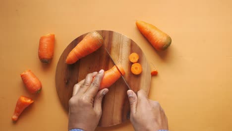 cutting carrots on a wooden board