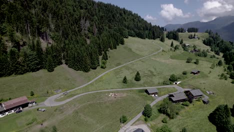 Sharp-corners-in-road-of-French-Alps-village-Les-Gets-mountain-slope-of-Mont-Chery-during-summer