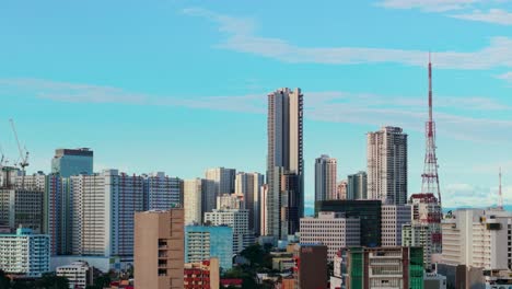 a stunning aerial shot of quezon city, philippines, showcasing the vibrant cityscape under a clear blue sky. the scene features a mix of towering skyscrapers and mid-rise buildings.