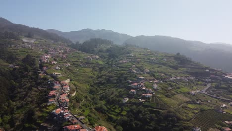 A-view-looking-over-the-residential-area-of-Ponta-Do-Sol,-with-a-beautiful-mountain-background