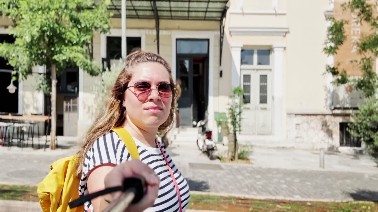 Candid Moment of a Woman Walking and Vlogging, Athens, Greece