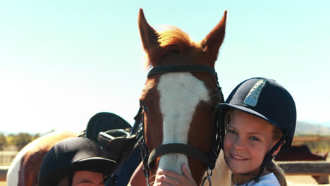 Siblings-touching-the-brown-horse-in-the-ranch-on-a-sunny-day-4k