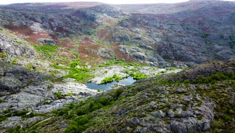 Rio-tera-canyon-and-lake-water-below-rocky-hillside-glowing-from-sunlight