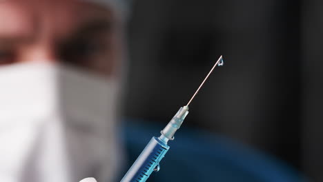 close up of dripping syringe