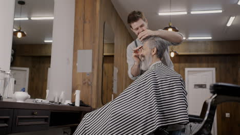 senior man getting a haircut at a barber shop