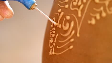 Intricate Detailing Process of Clay Art: A Close-up on the Application of Masterful Patterns to a Ceramic Surface Using Precision Tools