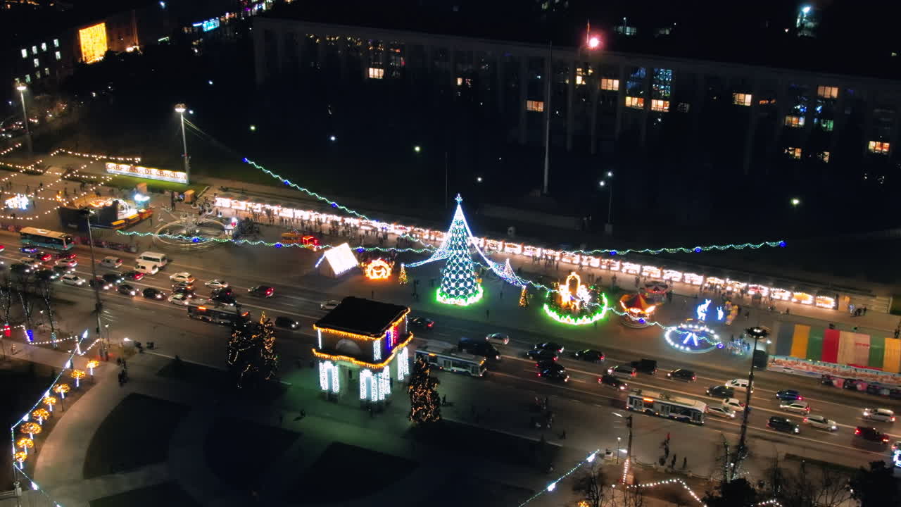 Aerial drone view of Chisinau at night, Moldova. View of city centre with Christmas decorations, buildings, road with cars, illumination