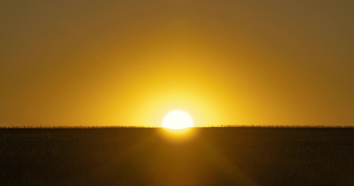 Golden Sunset Time Lapse Over a Rural Field Horizon