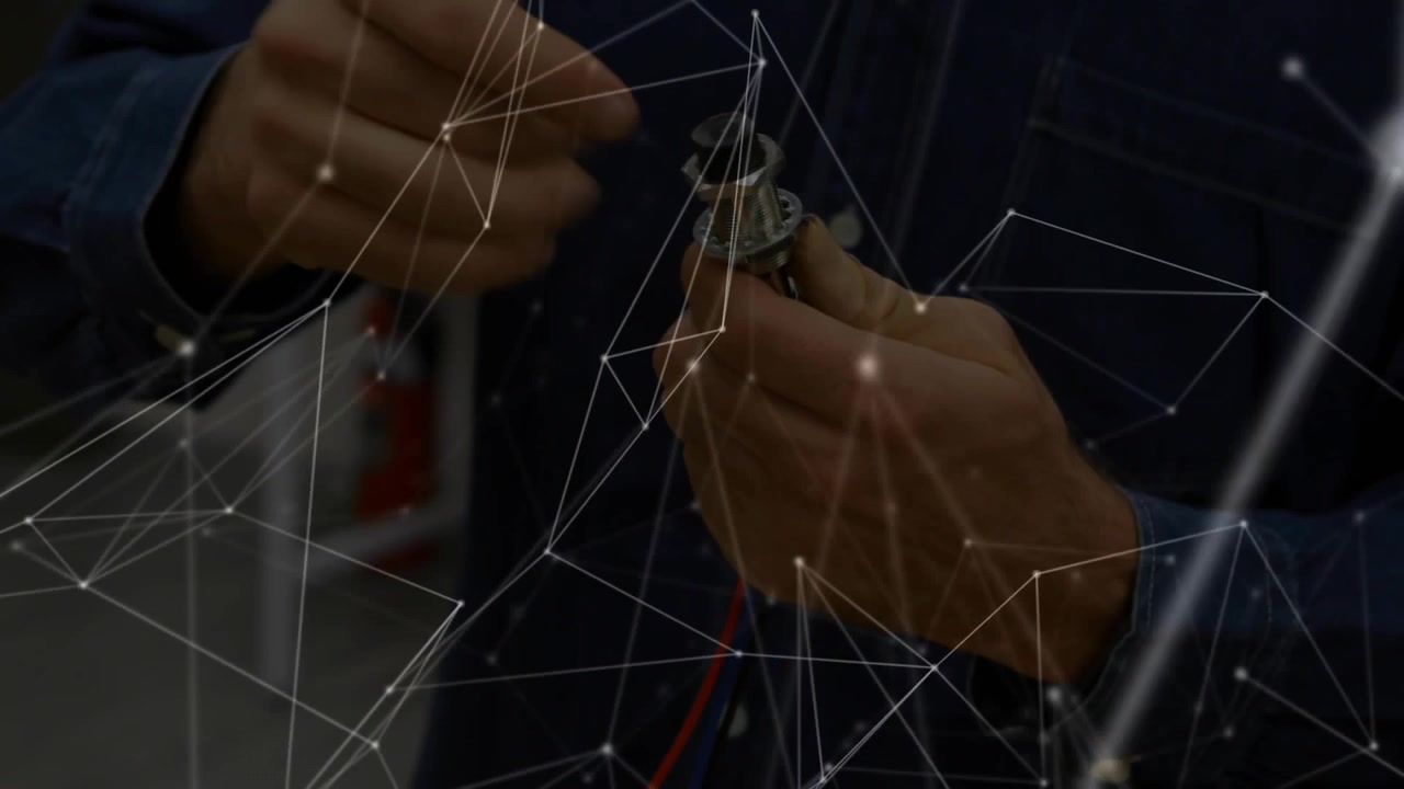 Technician picking up component with wires and unscrewing knurled cap inspecting electronics