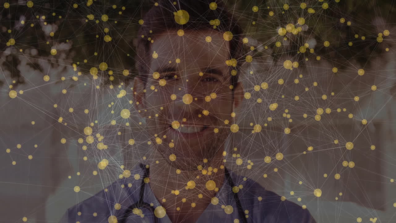 Animation of yellow nodes and connections over smiling healthcare professional outdoors