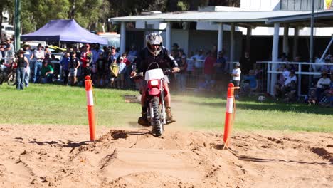 dirt bike rider navigating a sandy track