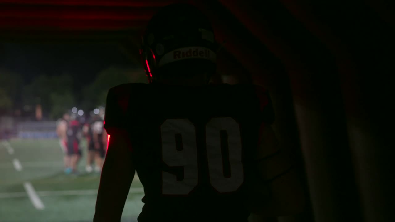 Football Player in Tunnel at Night