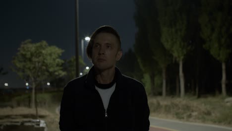 white-caucasian-male-man-model-stsaying-and-thinking-in-the-night-park-outdoors