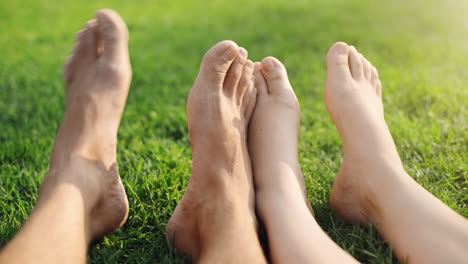 barefoot feet of young couple in love playing footsie