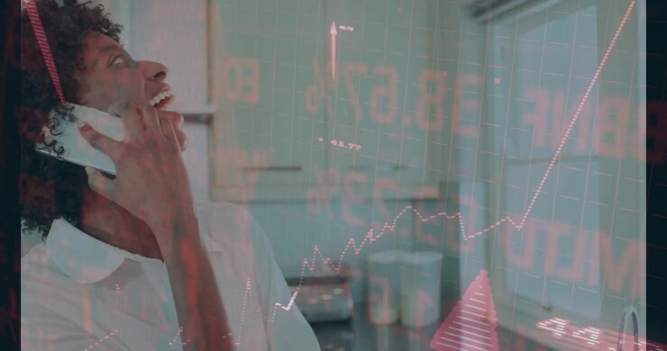Business woman lifting smartphone hearing growth data smiling as red charts floating above counter