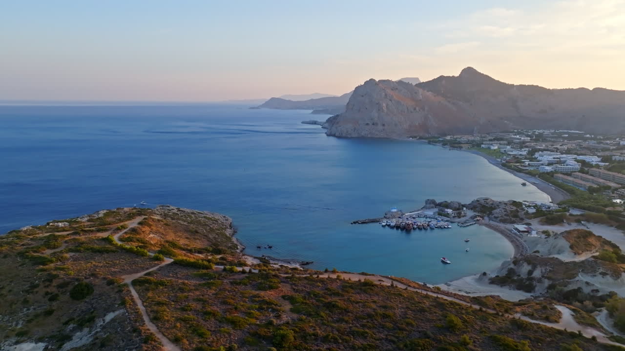 Aerial view following the coastline of Kolymbia, sunny evening in Rhodes, Greece
