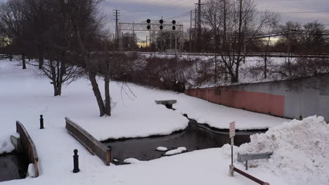 An-aerial-view-of-train-tracks-and-power-lines-in-the-morning,-after-a-snow-storm