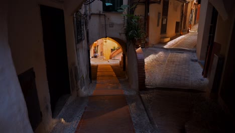 narrow medieval street in sanremo, italy. buildings made in classic style