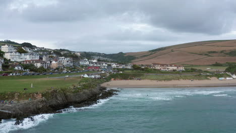 aerial dolly towards a coastal town at sunset