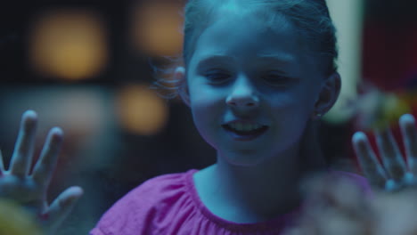 happy girl in aquarium looking at tropical fish curious child watching colorful sea life swimming in tank learning about marine animals in underwater ecosystem cute kid at oceanarium