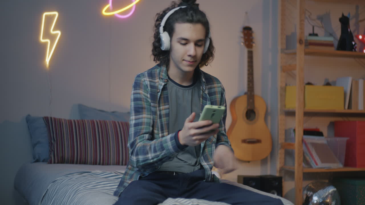 Teenage Boy Relaxing in His Bedroom