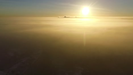 dense fog over city valmiera in early winter morning sunlight aerial footage wide shot