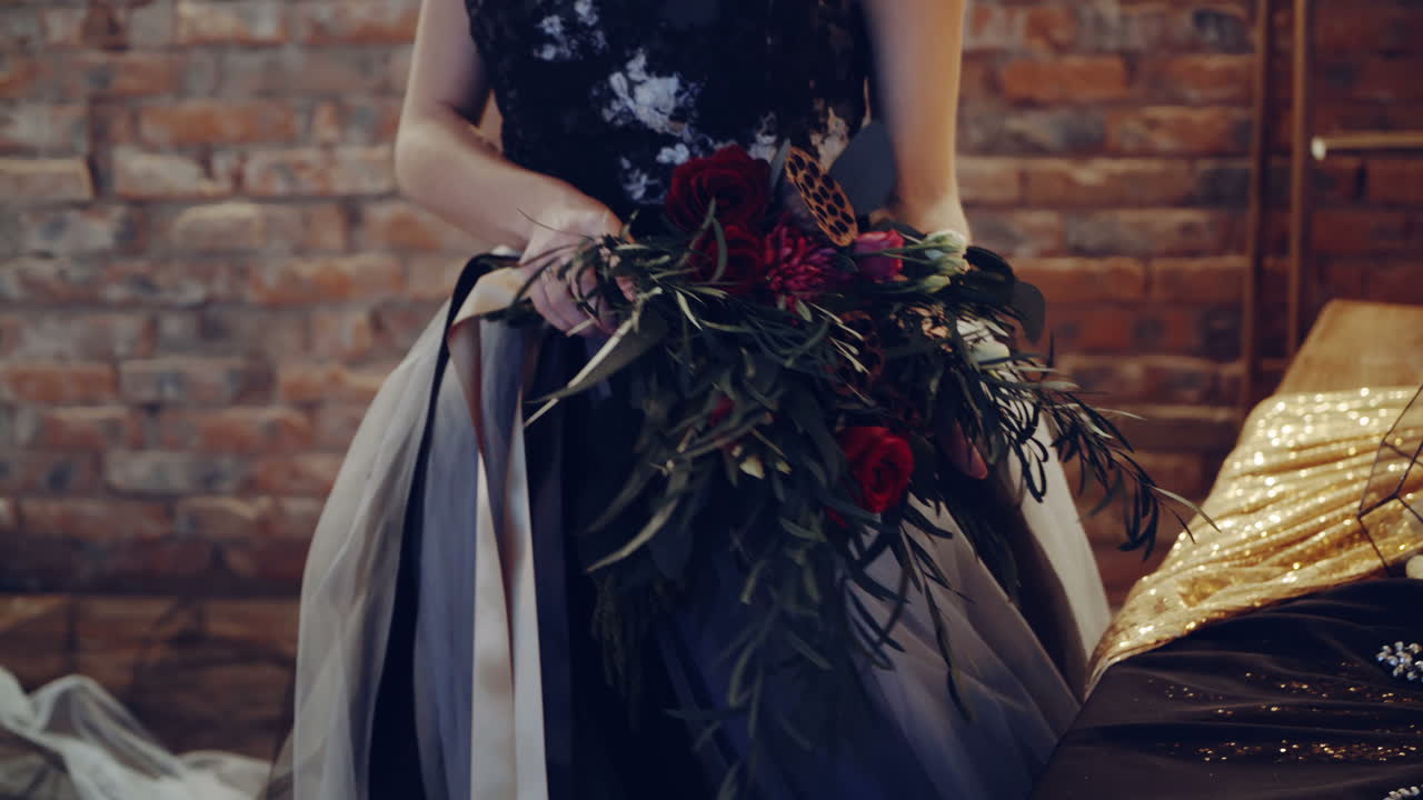 Woman in witch costume. Young witch woman sitting by the table in room