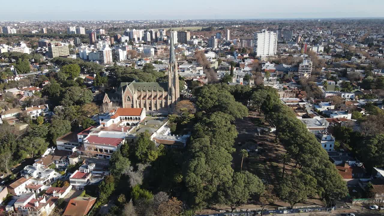 Aerial view of a city featuring a prominent church and lush green spaces