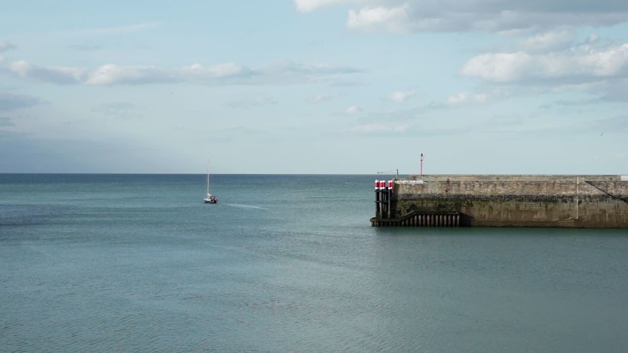 Sailboat in France leaving the harbour for an adventure.