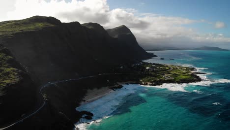 The sunset over beautiful mountains on the coast of Oahu, Hawaii.