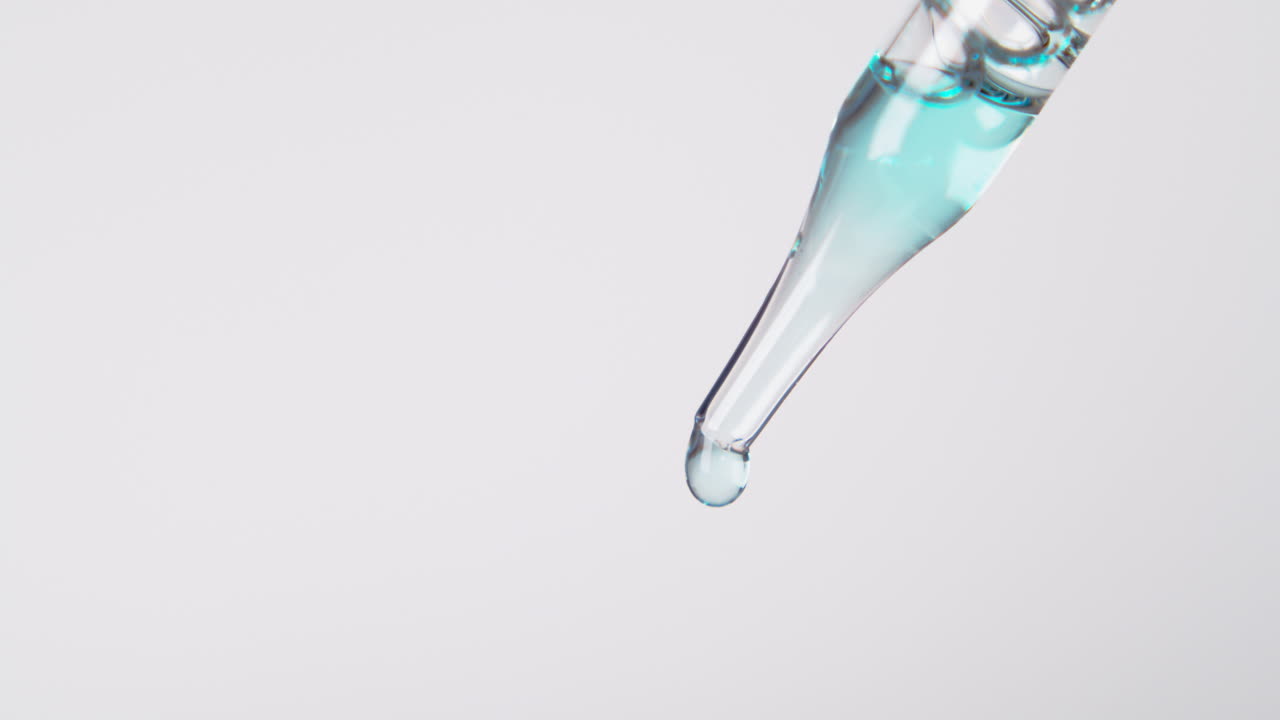 Simple dropper and droplet with light blue liquid and white background