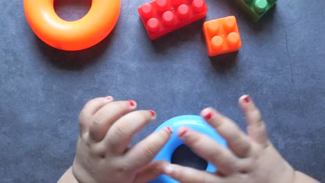 toddler playing with rings and blocks