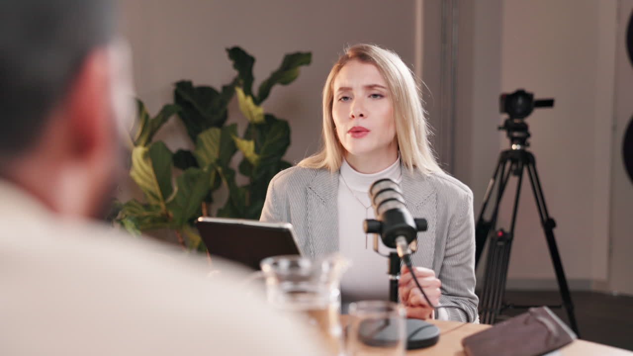 Woman recording a podcast in a studio setting