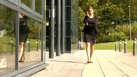 Businesswoman-using-her-phone-outside