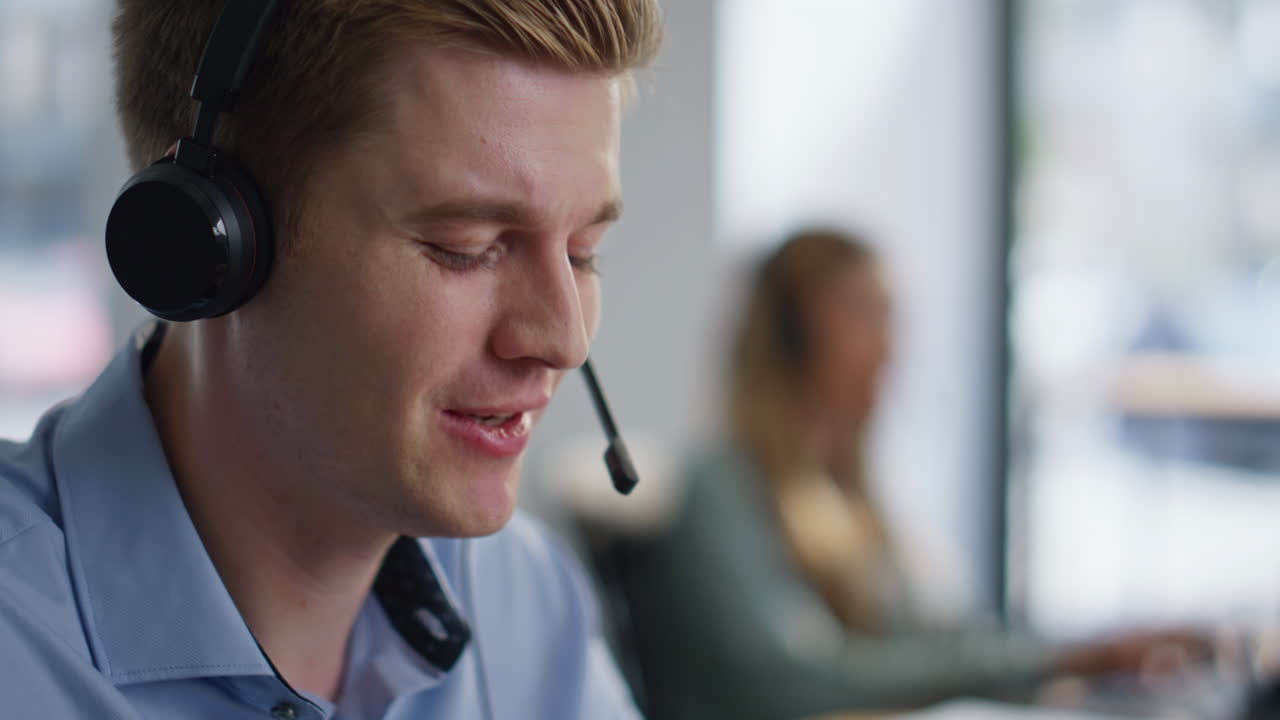 Call center specialists working at office open space providing customer support
