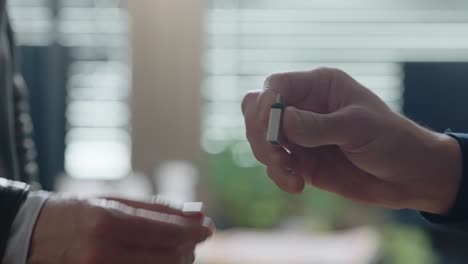 hands discreetly passing a small usb drive, followed by a handshake. confidential data transfer, secret exchange, or potential digital theft. cybersecurity, corporate secrecy, crime-related dealings.