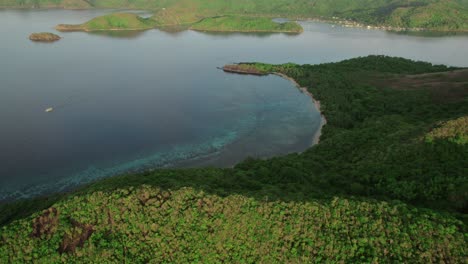 aerial forward shot capturing lake surrounded in greenery in philippines.