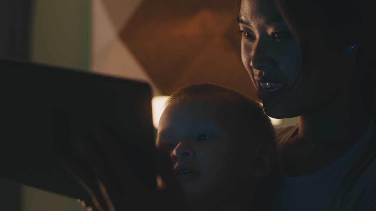 Mother and Child Enjoying Tablet Time at Night