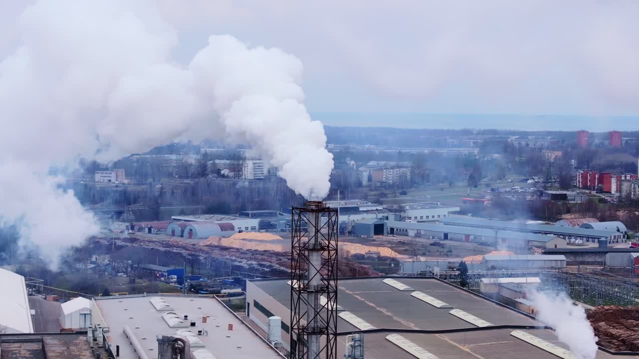 Industrial pollution shows thick smoke rising on overcast day, climate crisis