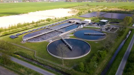 Panorama-Luftaufnahme-Einer-Großen-Wasseraufbereitungsanlage-Mit-Rührtanks-Und-Belüftungskammer-In-Einer-Grasbewachsenen-Landschaft